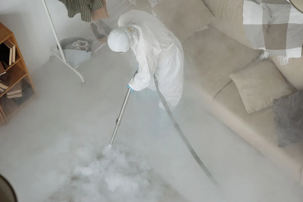 Biohazard cleanup technician in protective equipment, Garfield, TX